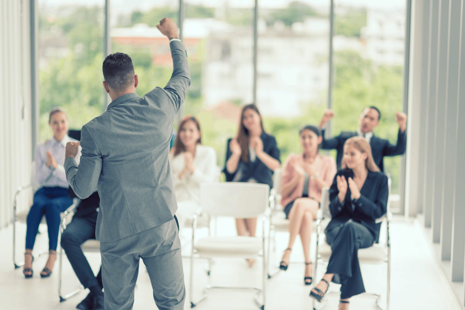 A speaker delivers a presentation to an engaged audience of professionals, showcasing quality training.