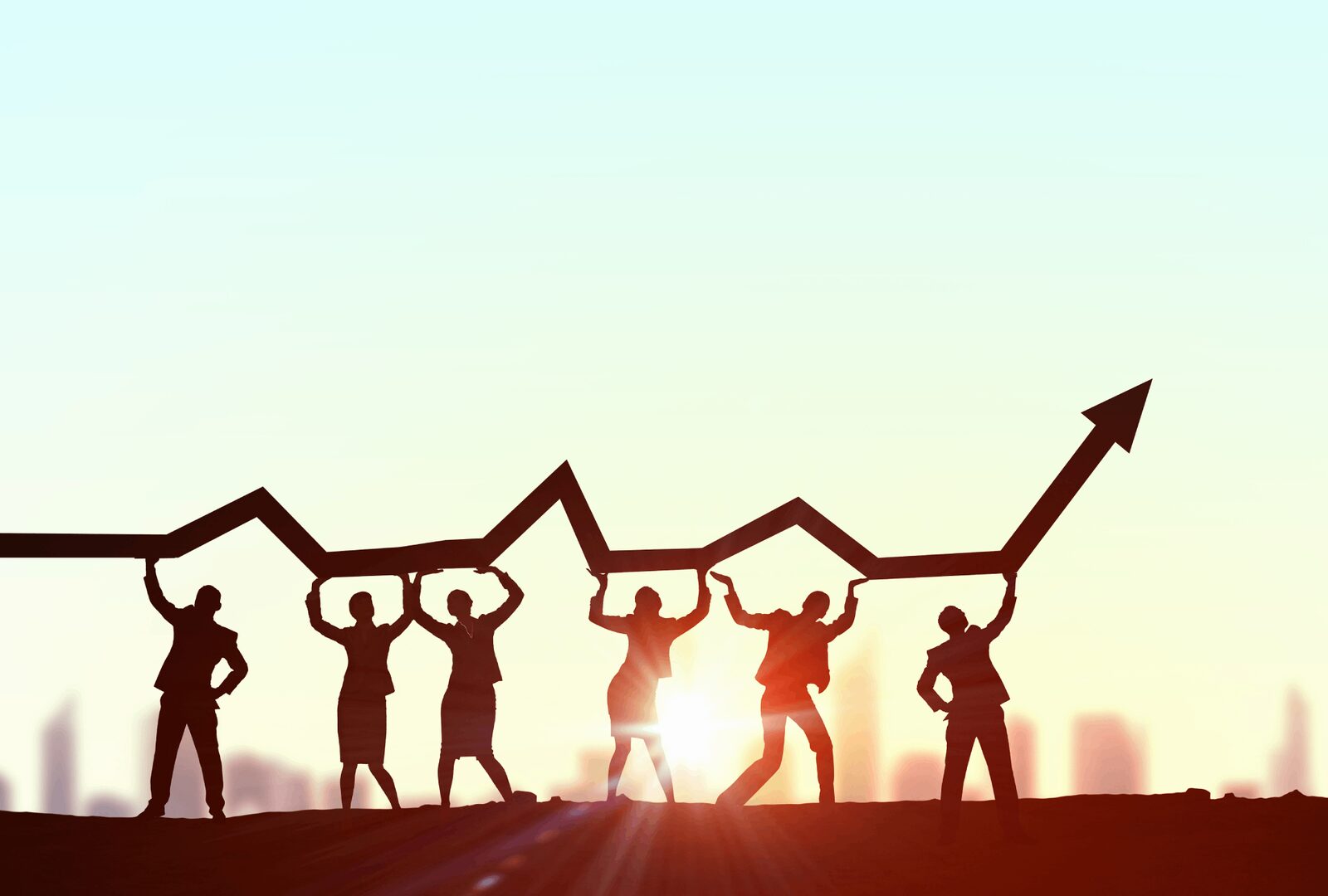 Team Growth | Career Calling International A silhouetted team supports an upward arrow symbolizing business growth and success in vocational education training.