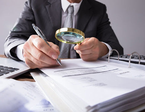 A professional reviews documents, highlighting the importance of vet compliance for RTO registration renewal.