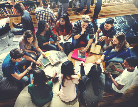 Students collaborate in a library setting, demonstrating the benefits of quality VET compliance.