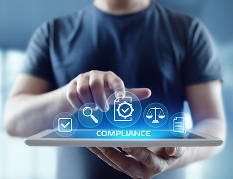 A person uses a tablet to review compliance information, supporting vet compliance and digital transformation.