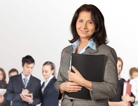 Business Professionals | Career Calling International A businesswoman leads a team of office workers, demonstrating Career Calling International’s commitment to quality.